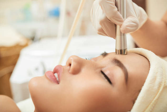woman receiving a microneedling session